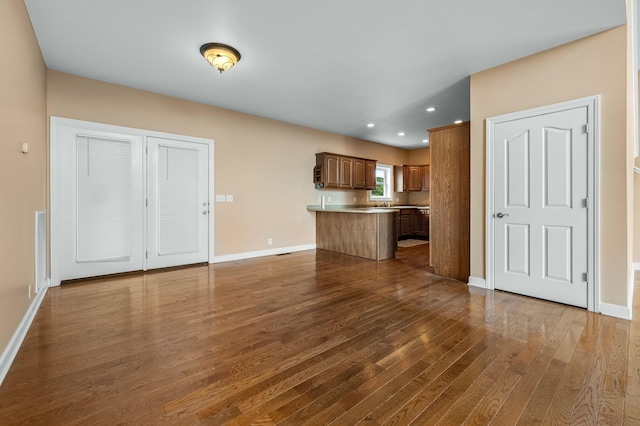 unfurnished living room with dark hardwood / wood-style floors