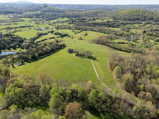 birds eye view of property featuring a rural view and a water view