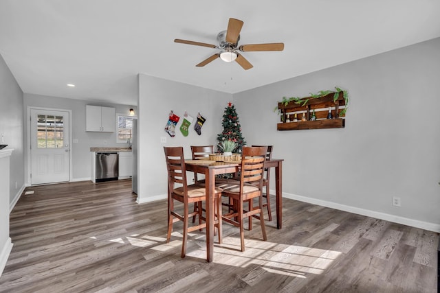 dining area featuring wood-type flooring and ceiling fan