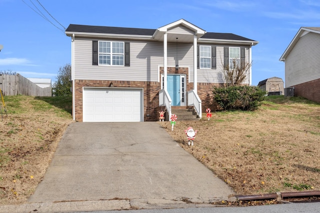 bi-level home with a garage and a front lawn