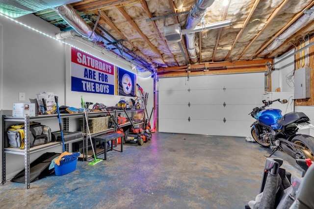 garage featuring electric panel and a garage door opener