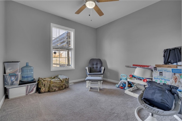 sitting room with carpet flooring and ceiling fan