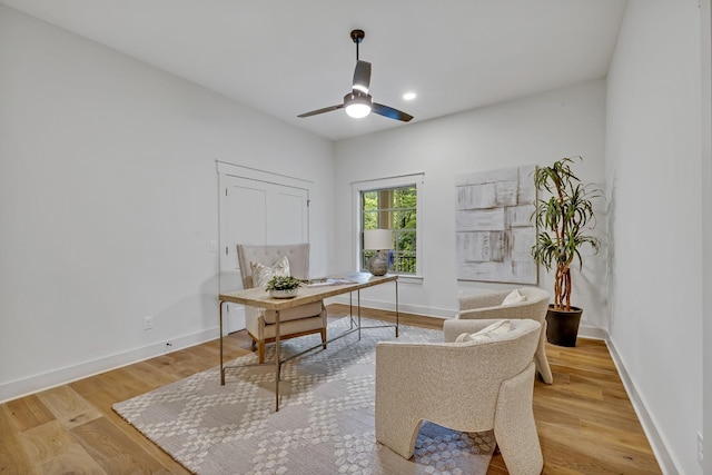 home office featuring light hardwood / wood-style flooring and ceiling fan