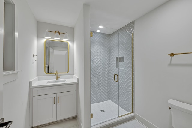 bathroom featuring tile patterned flooring, vanity, toilet, and an enclosed shower