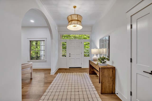 entrance foyer featuring light hardwood / wood-style floors and crown molding