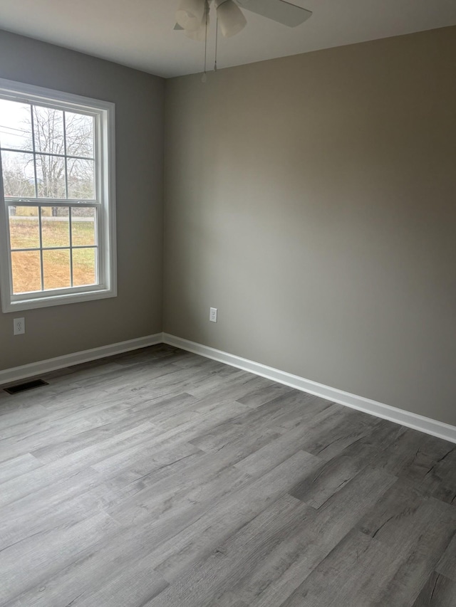 spare room with ceiling fan and light hardwood / wood-style flooring