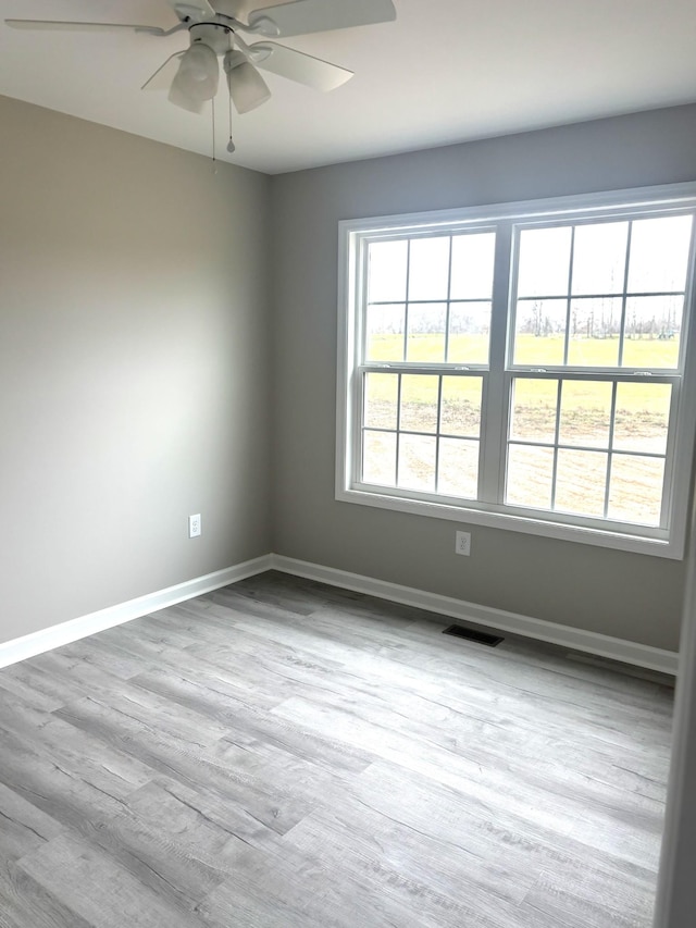 spare room featuring ceiling fan and light wood-type flooring