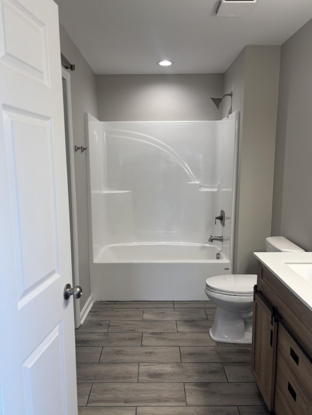 full bathroom featuring shower / washtub combination, vanity, and toilet