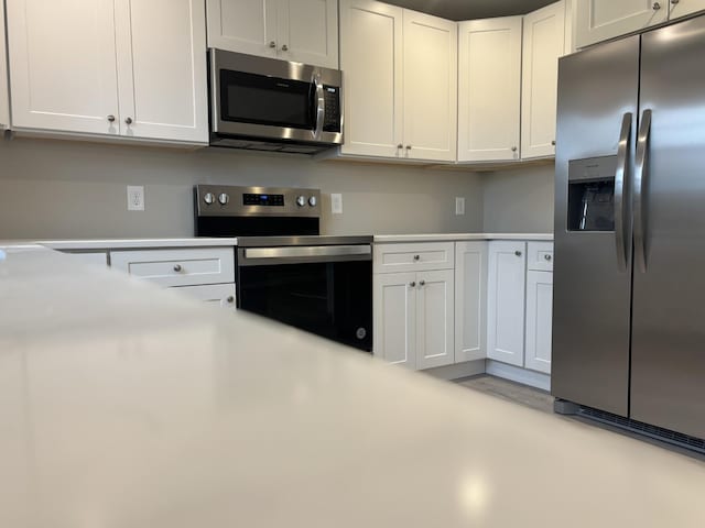 kitchen featuring white cabinets and appliances with stainless steel finishes