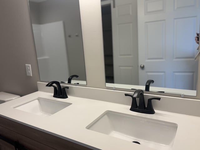 bathroom featuring vanity and toilet