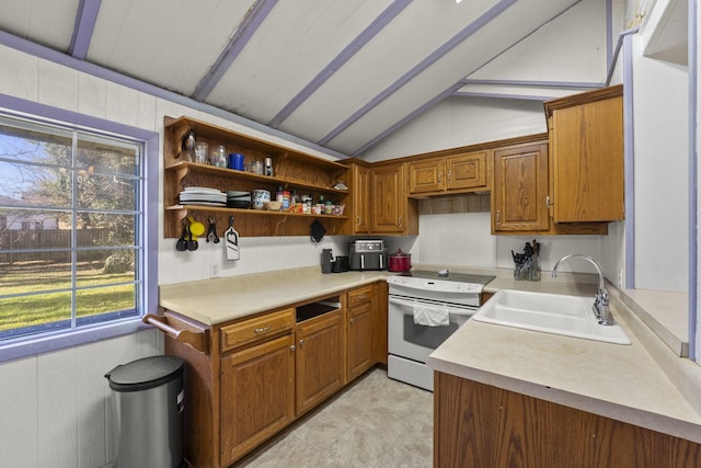 kitchen with vaulted ceiling, white electric stove, plenty of natural light, and sink