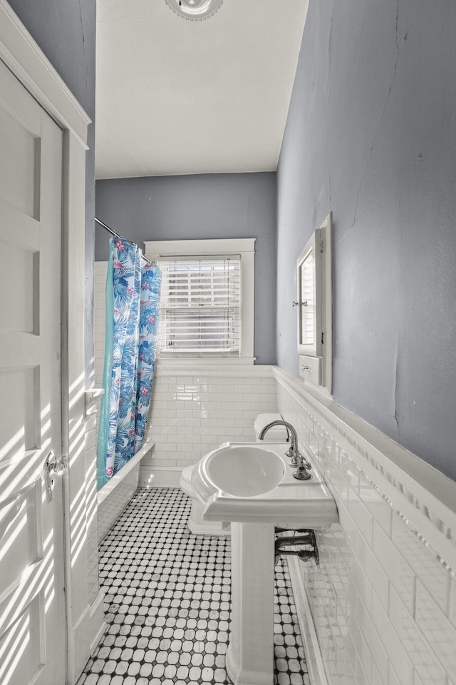 bathroom featuring tile patterned floors and shower / tub combo with curtain