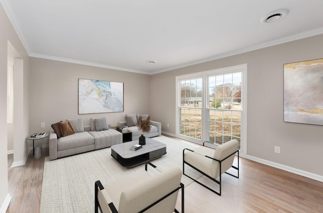 living room featuring light wood-type flooring and crown molding