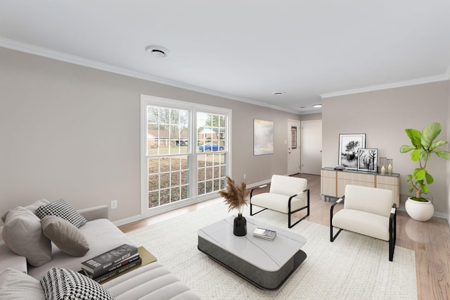 living room with wood-type flooring and ornamental molding