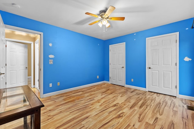 unfurnished bedroom with ceiling fan and light hardwood / wood-style floors