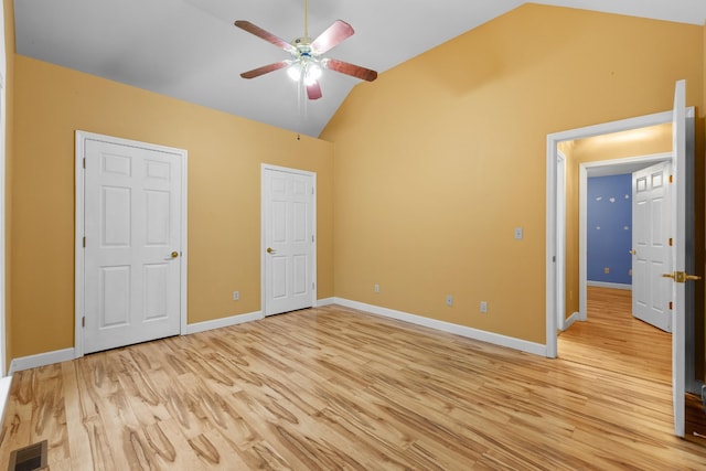 unfurnished bedroom featuring ceiling fan, light hardwood / wood-style floors, and lofted ceiling