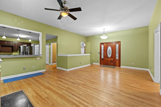 entryway with light wood-type flooring and ceiling fan