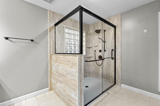 bathroom featuring tile patterned flooring and an enclosed shower