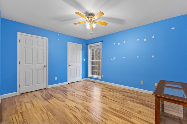 unfurnished bedroom with ceiling fan and light hardwood / wood-style flooring