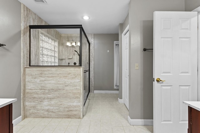 bathroom with vanity and a shower with door