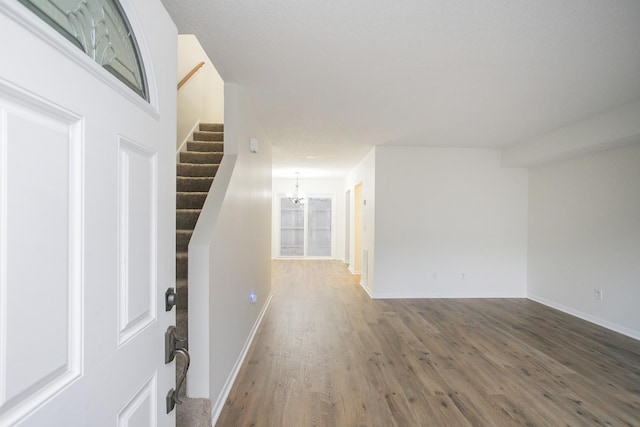 interior space featuring wood-type flooring and an inviting chandelier