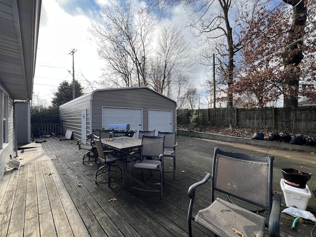 deck featuring a garage and an outdoor structure