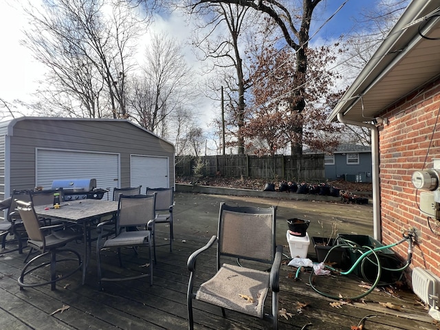 wooden deck with an outdoor structure and grilling area