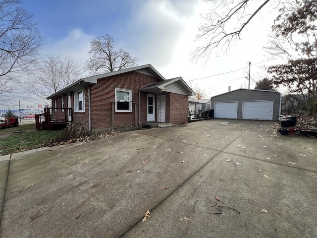 single story home with a garage and an outbuilding