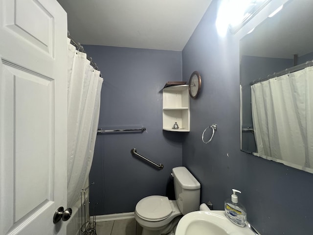 bathroom featuring tile patterned floors and toilet