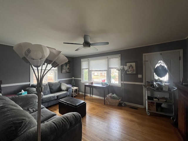 living room featuring ceiling fan, hardwood / wood-style floors, and crown molding