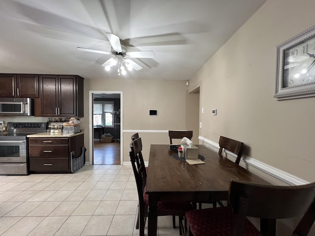 dining space featuring ceiling fan and light tile patterned flooring