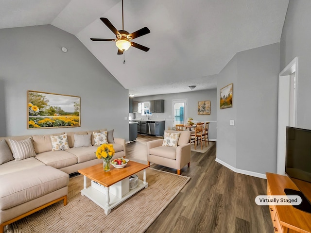 living room featuring hardwood / wood-style flooring, ceiling fan, and high vaulted ceiling