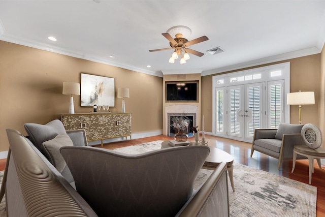 living room with ceiling fan, french doors, wood-type flooring, and ornamental molding