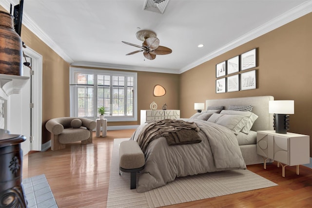 bedroom with ceiling fan, light hardwood / wood-style floors, and crown molding