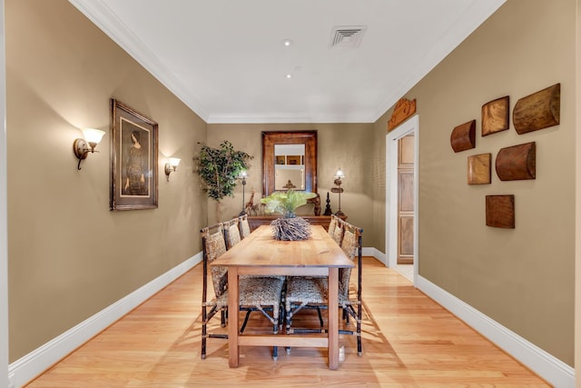 dining room featuring light hardwood / wood-style floors and ornamental molding