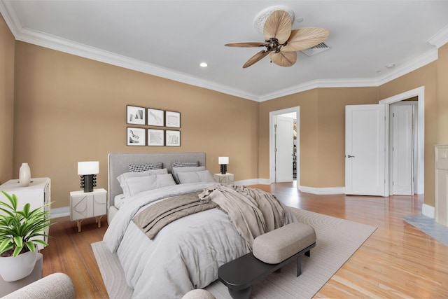 bedroom featuring hardwood / wood-style floors, ceiling fan, and crown molding