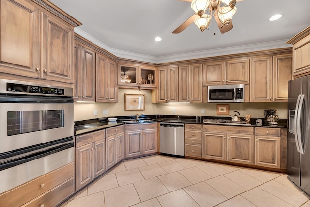 kitchen with crown molding, ceiling fan, light tile patterned flooring, and appliances with stainless steel finishes