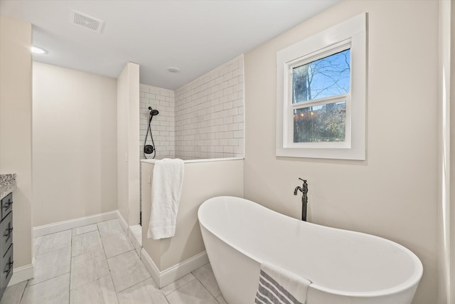 bathroom featuring vanity and independent shower and bath