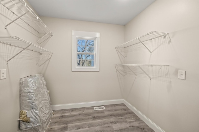 walk in closet featuring hardwood / wood-style floors