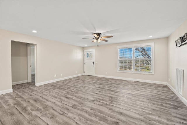 unfurnished living room featuring light hardwood / wood-style flooring and ceiling fan