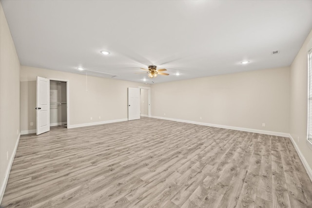 spare room with ceiling fan and light wood-type flooring