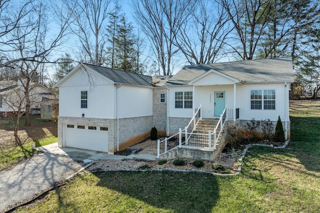 view of front of property with a front yard and a garage