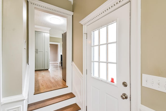 doorway with a textured ceiling and a wealth of natural light