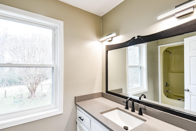 bathroom with shower / bathing tub combination and vanity