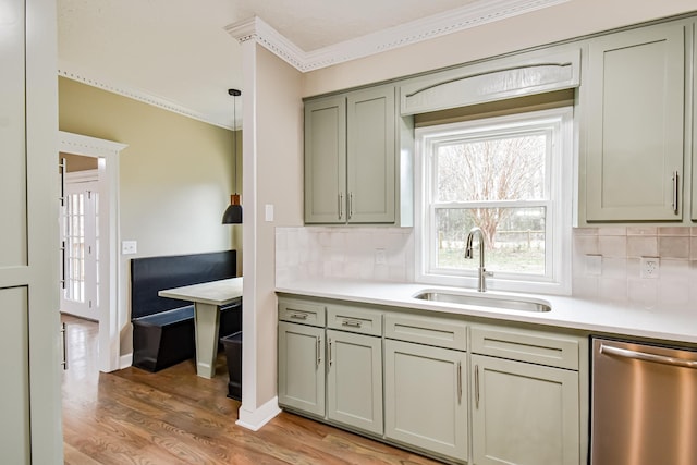 kitchen featuring stainless steel dishwasher, light hardwood / wood-style floors, sink, and backsplash