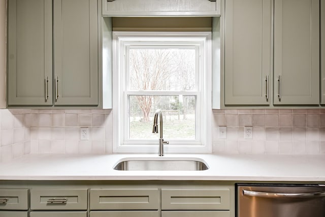 kitchen with dishwasher, sink, and tasteful backsplash