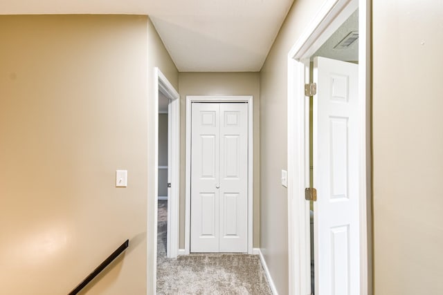 hall featuring light colored carpet