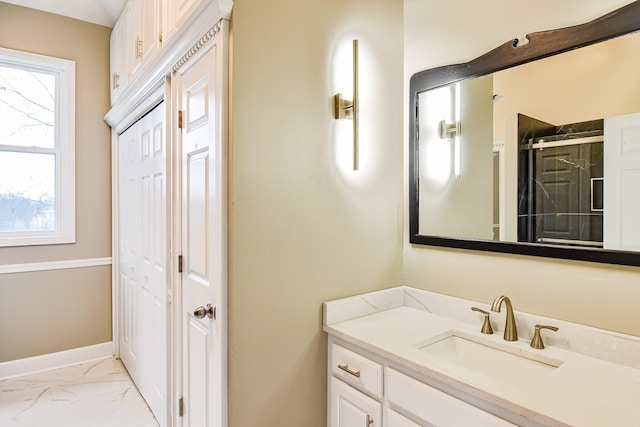 bathroom featuring plenty of natural light, a shower with shower door, and vanity