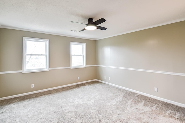 unfurnished room with crown molding, carpet floors, and ceiling fan