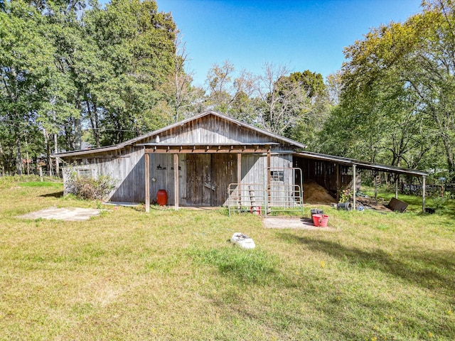 view of outbuilding with a yard